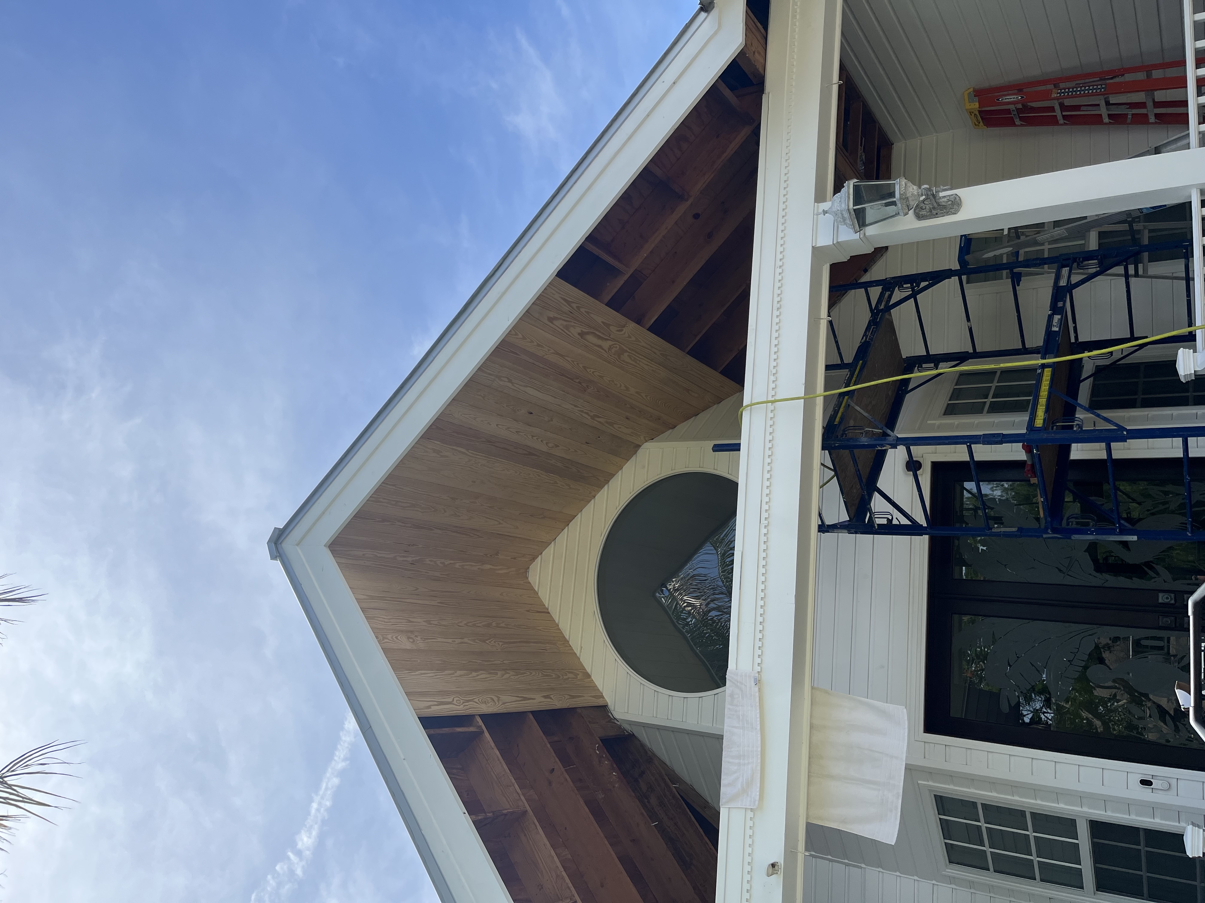 Partially installed tongue and groove boards beginning to cover the gable ceiling