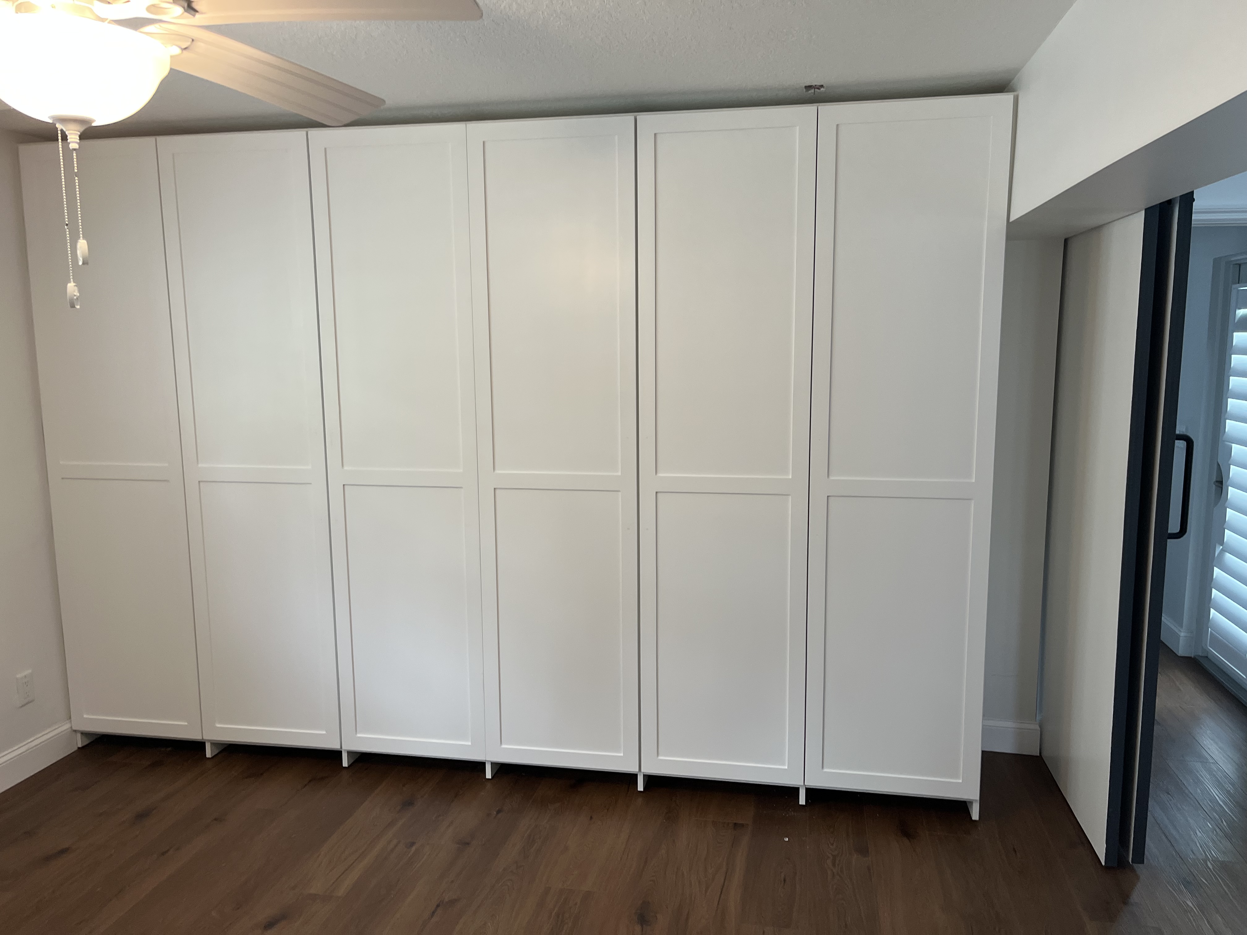 Closet project with white panel doors added across the front