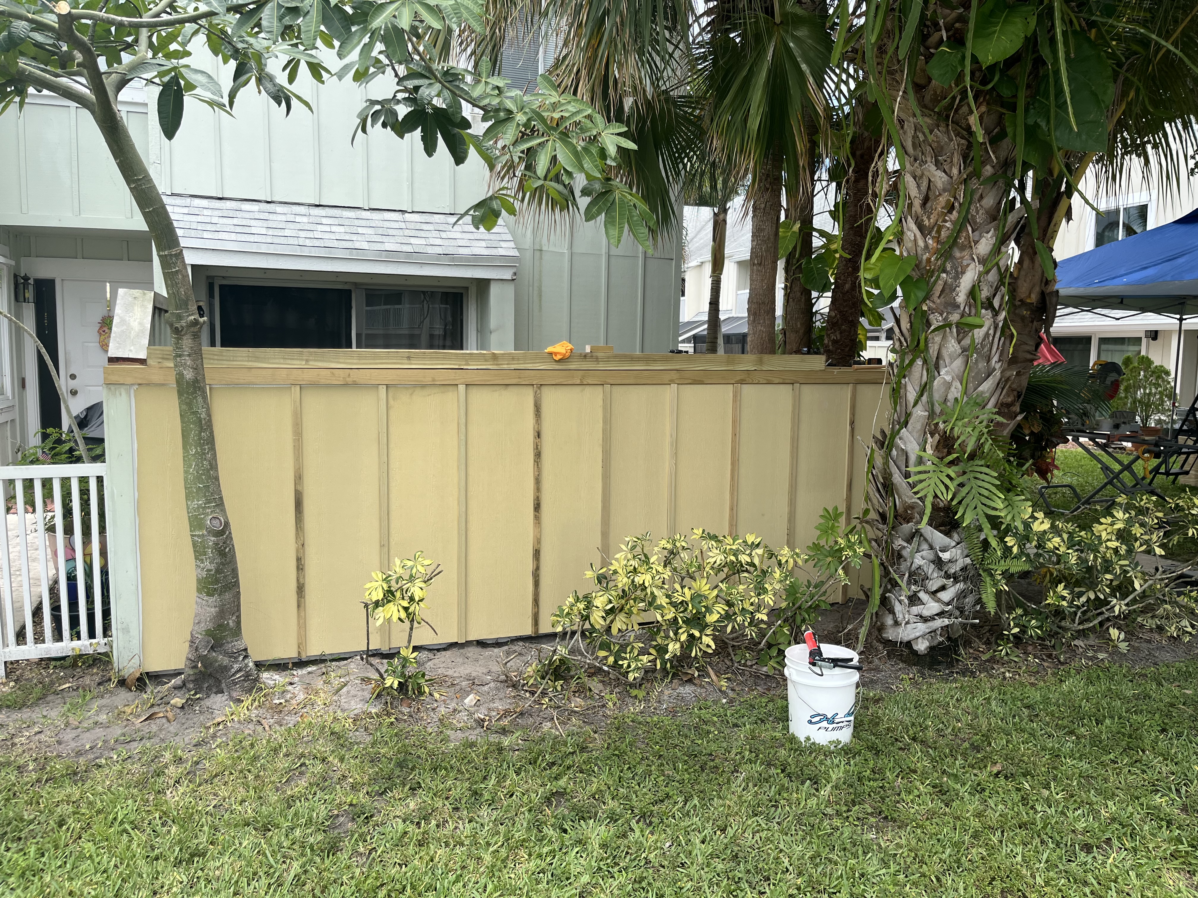 Finished exterior side of the new fence enclosing the upgraded backyard turf area
