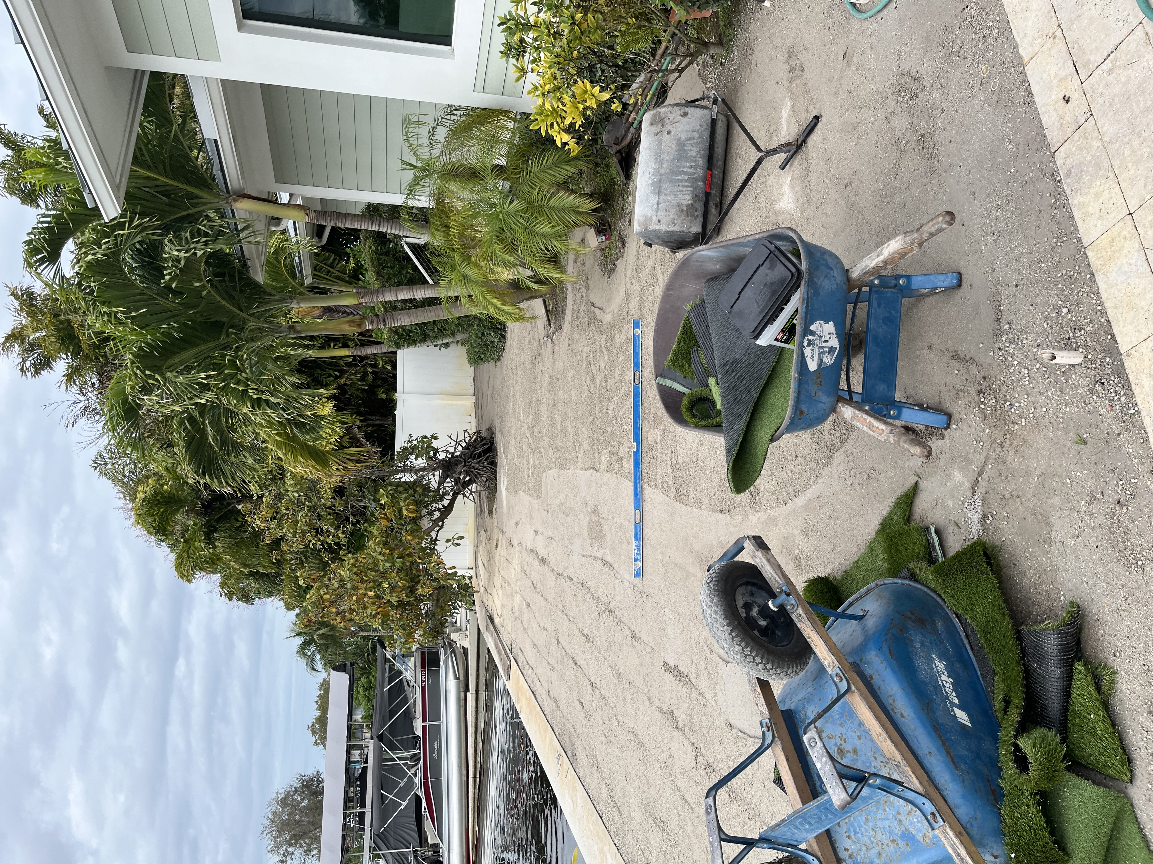 Yard area during early grading and preparation for an artificial turf installation