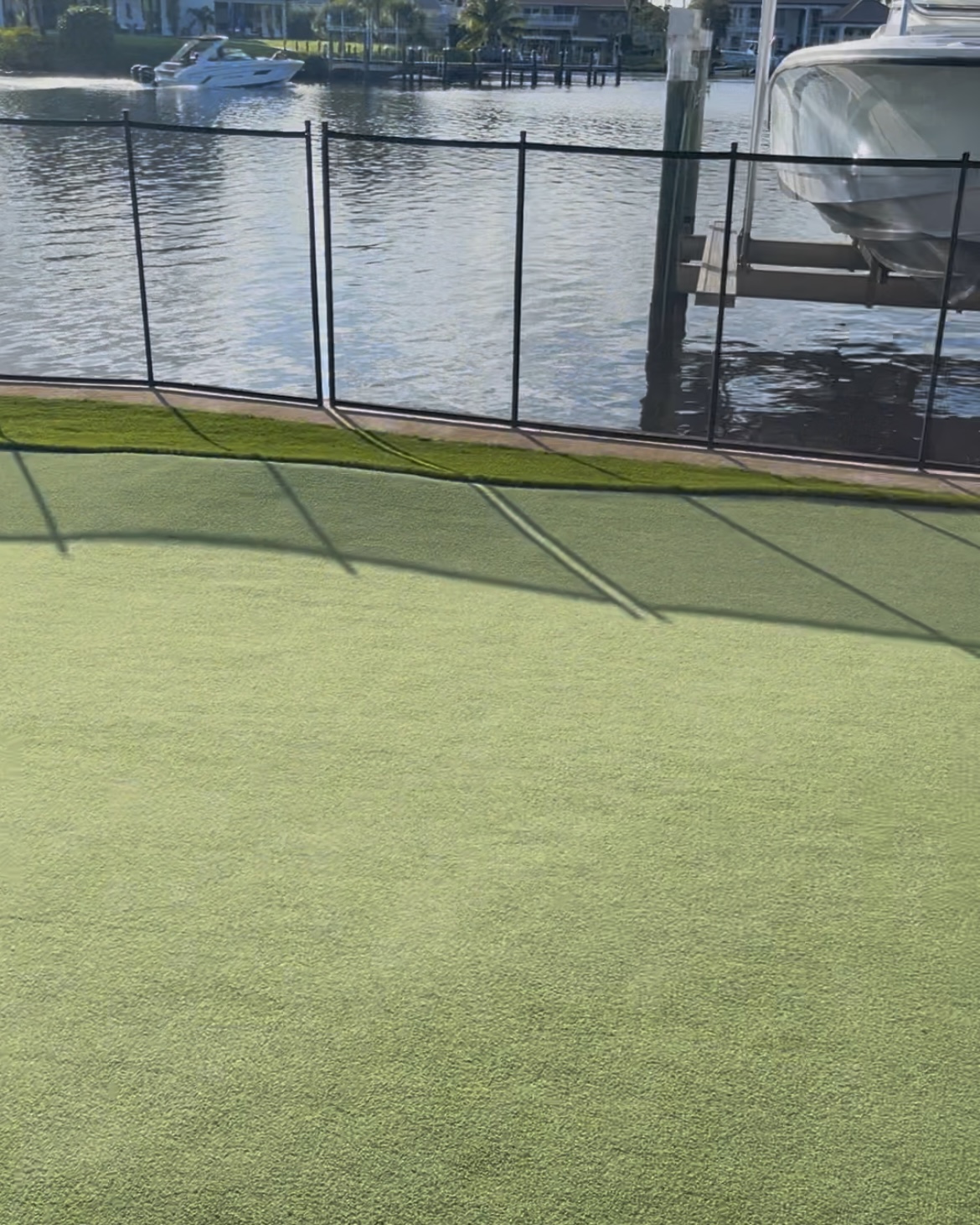 Completed artificial turf surface viewed toward the waterfront fence